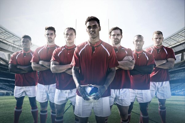 Composite image of rugby team standing on the field.