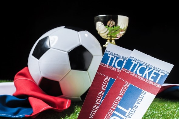 Football cup with football ball on grass